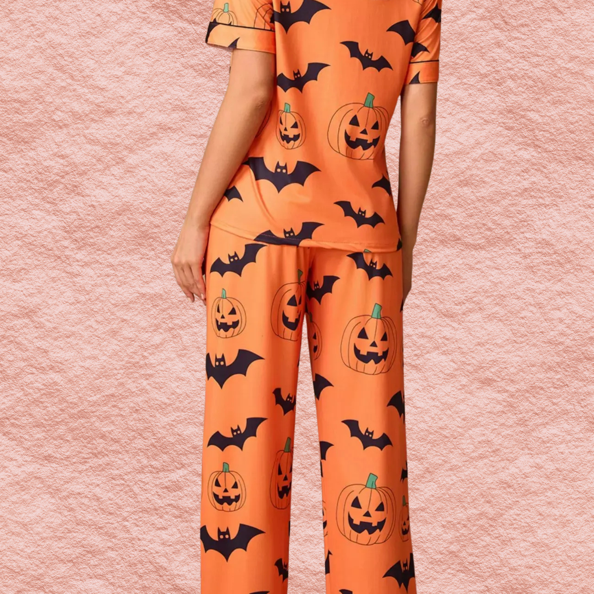 Orange Halloween pajama set close-up, matching lounge pants with pumpkin and bat print
