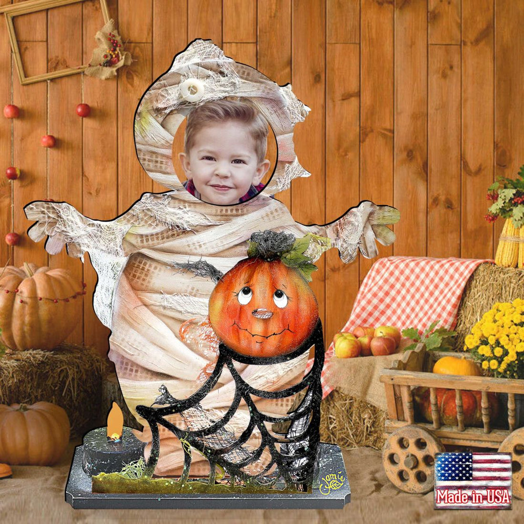 Halloween yard decor figure with mummy-clad child and jack-o’-lantern on base with “Made in USA” tag