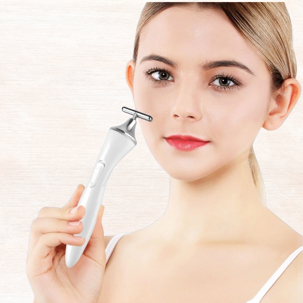White T-shape microcurrent facial massager device held near cheek