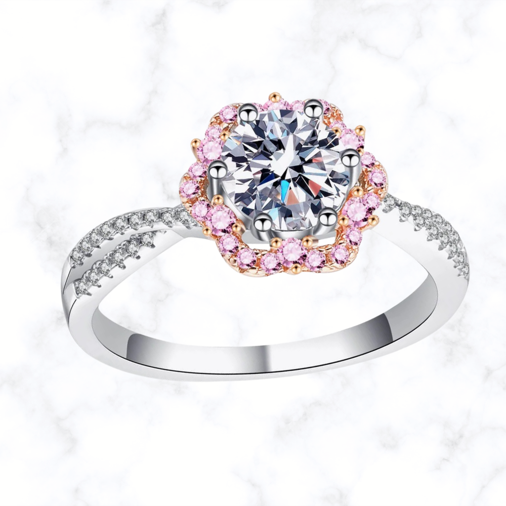 Silver ring with round center stone, pink flower halo and crisscross prong setting