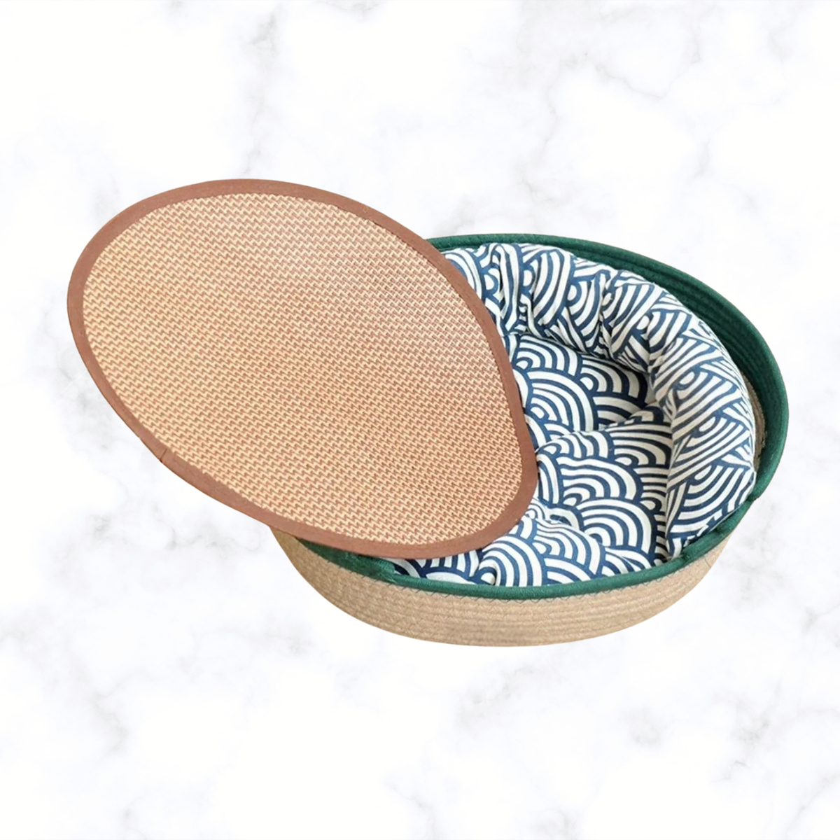 Woven pet nest with dark green rim, brown woven top, blue zebra-pattern cushion.