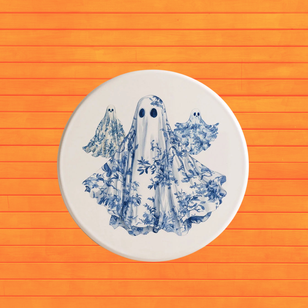 Blue-and-white ghost Halloween coaster with floral drape on a white round base