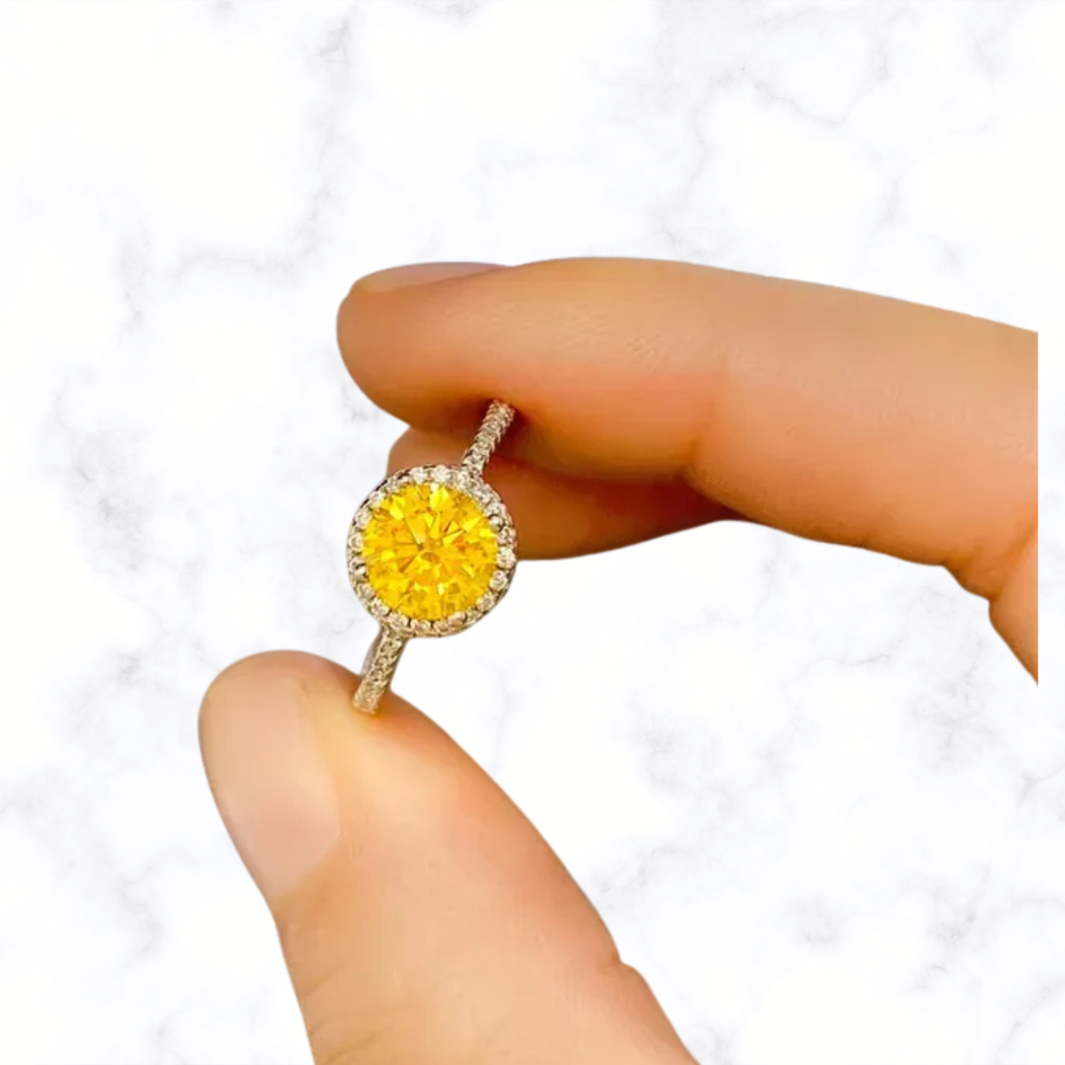 Round yellow moissanite halo ring in 925 sterling silver, close-up on finger