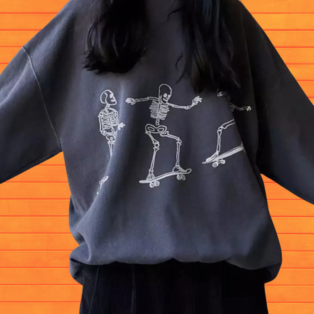 Dark gray oversized sweatshirt with white skeleton skateboard graphic on front