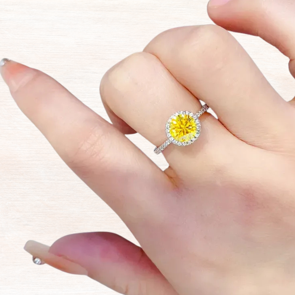 Sterling silver ring with yellow moissanite halo on a hand