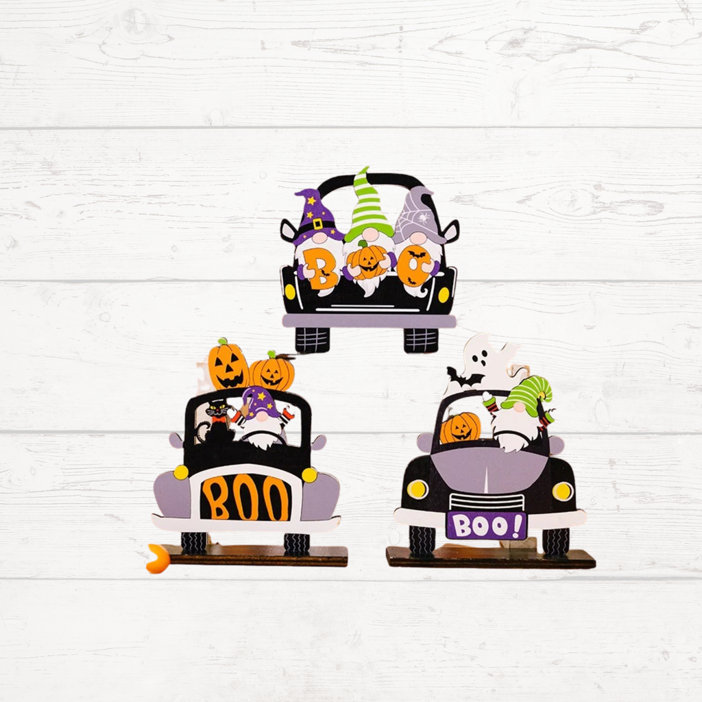 Three car-shaped Halloween ornaments with pumpkin jack-o'-lanterns and 'BOO!' signs