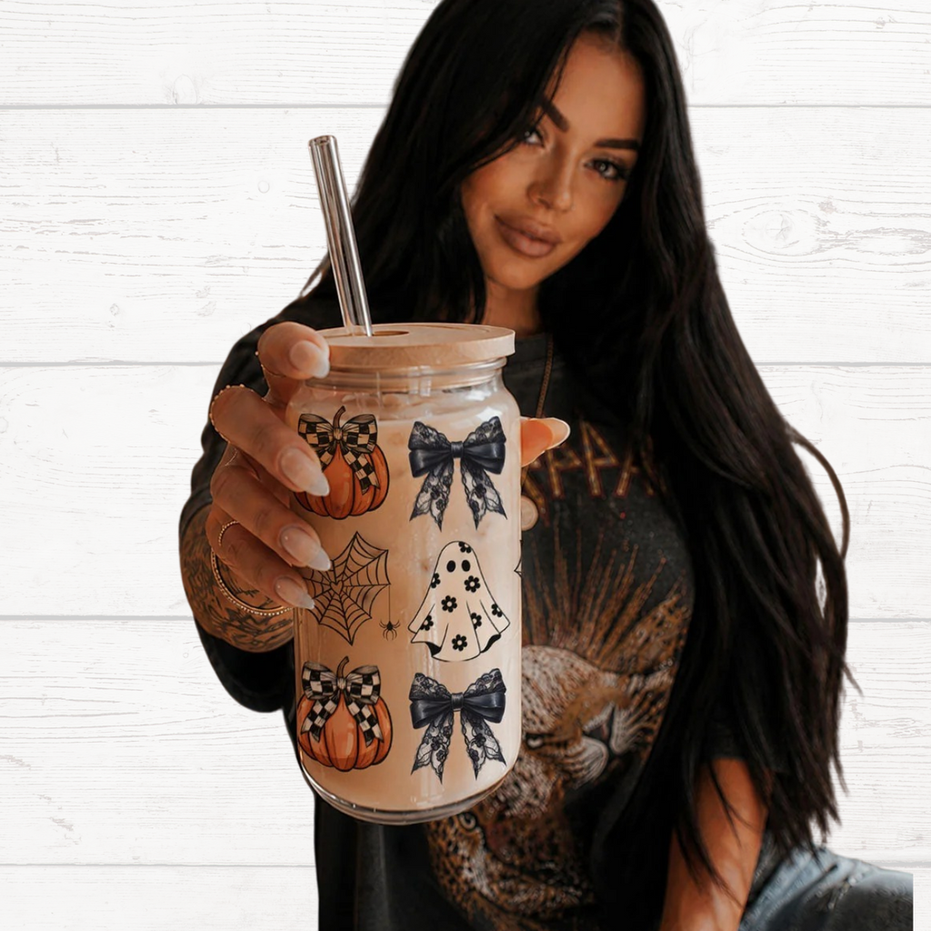Woman holding a 20oz Halloween drink jar with straw and wooden lid, pumpkins and bats