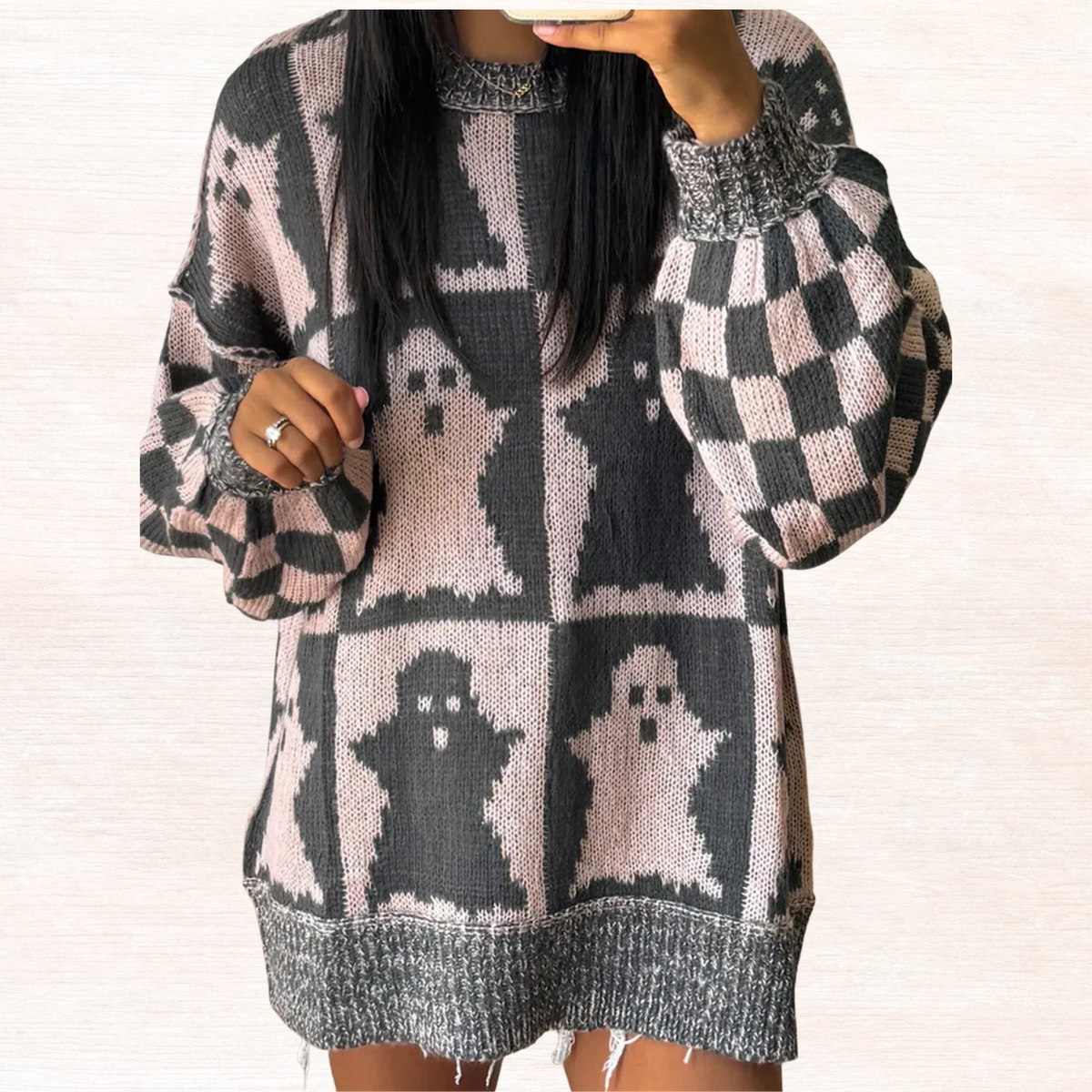 Black and white ghost knit long-sleeve sweater with dropped shoulders and checker squares