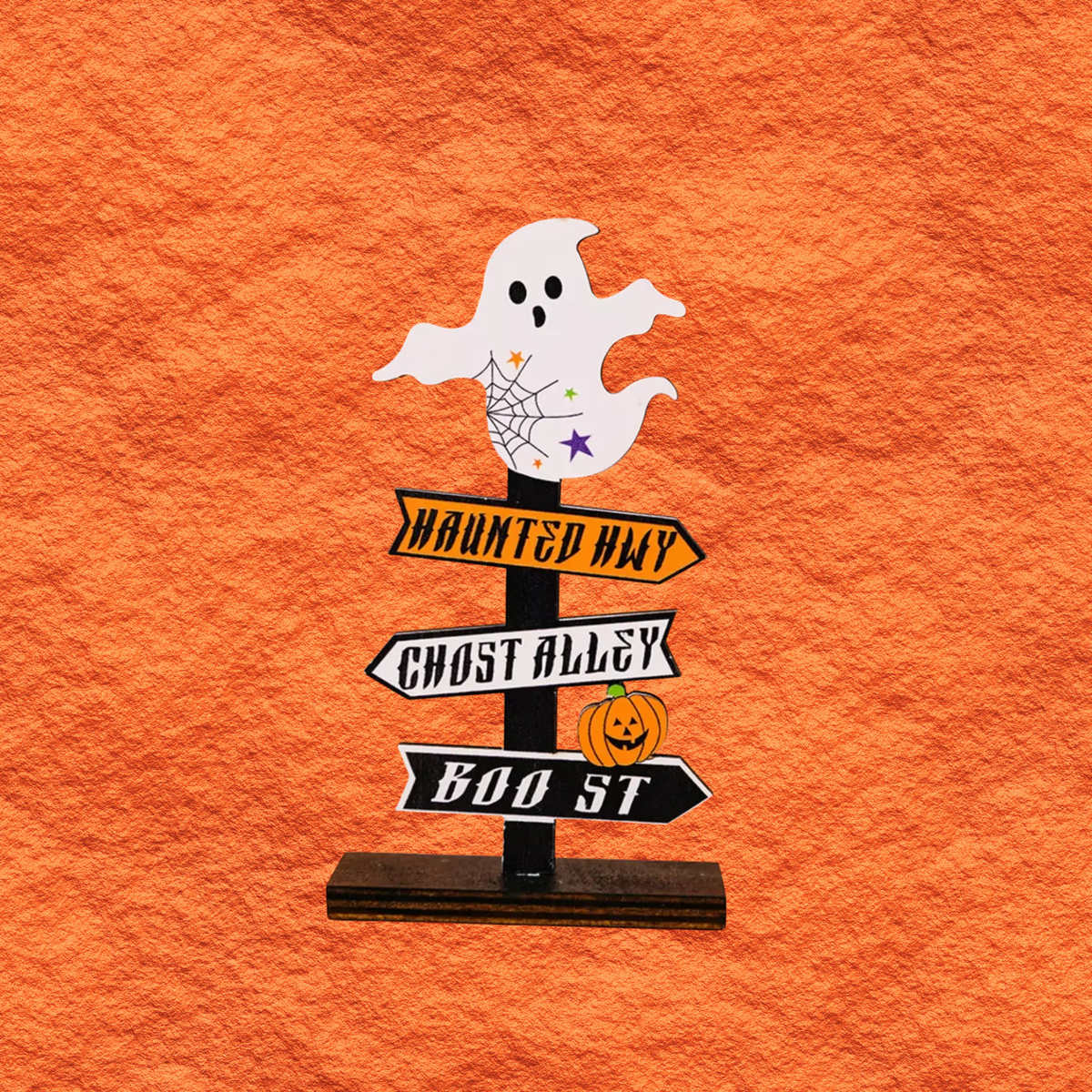 Halloween wooden signpost ornament with white ghost holding stars, and haunted way/ghost signs