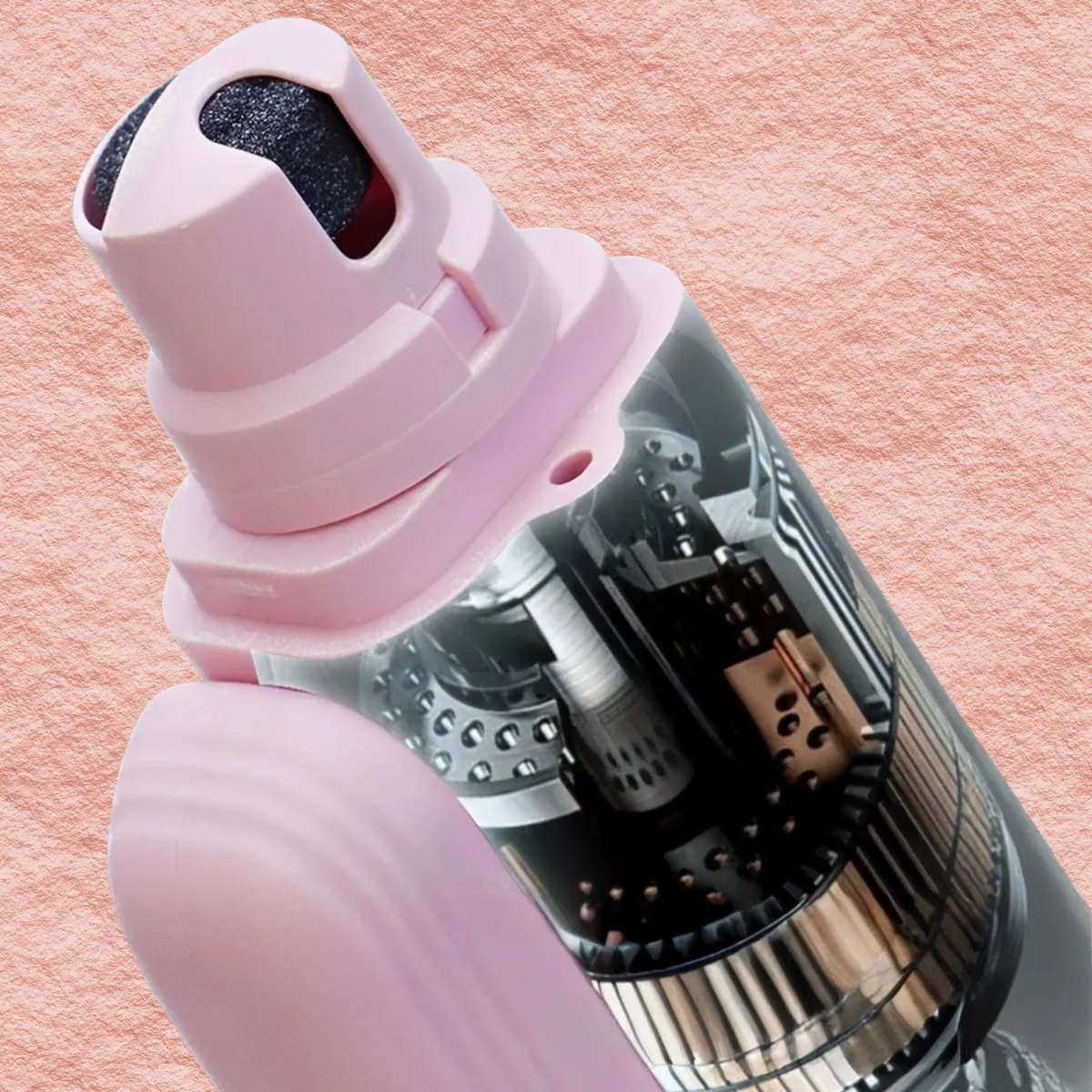 Electric pet nail grinder detail, blush pink housing with exposed metal grinding cylinder