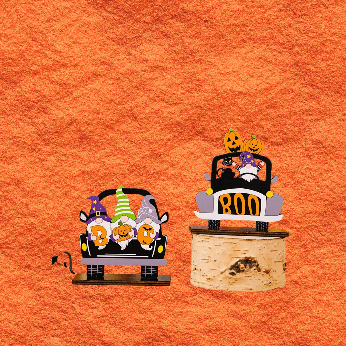 Car-shaped Halloween ornaments with pumpkins and 'BOO!' signs on small display stands