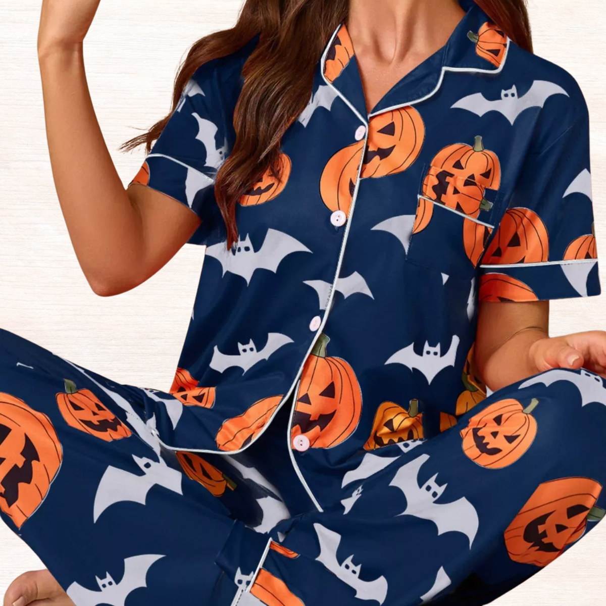 Navy button-down pajama set with orange pumpkin and bat print, short sleeves and pants