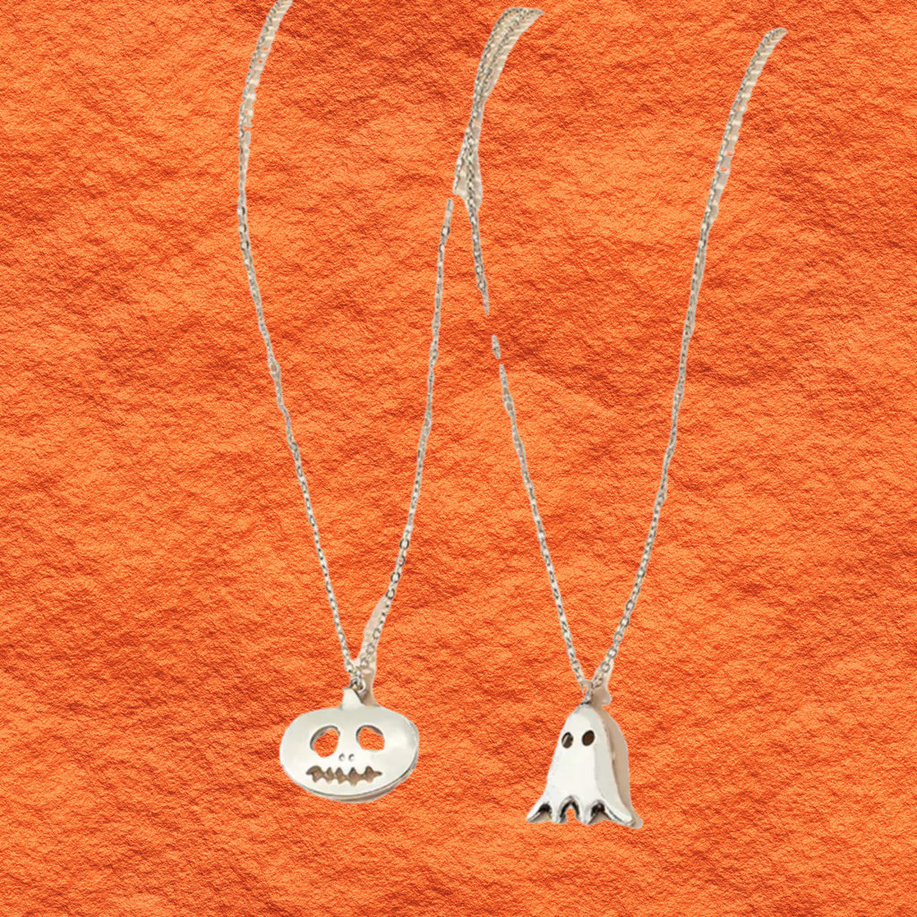 Silver pendant necklace duo with round jack-o-lantern charm and white ghost charm.
