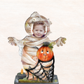 Halloween yard decor figure: child in mummy costume holding jack-o’-lantern on dark base