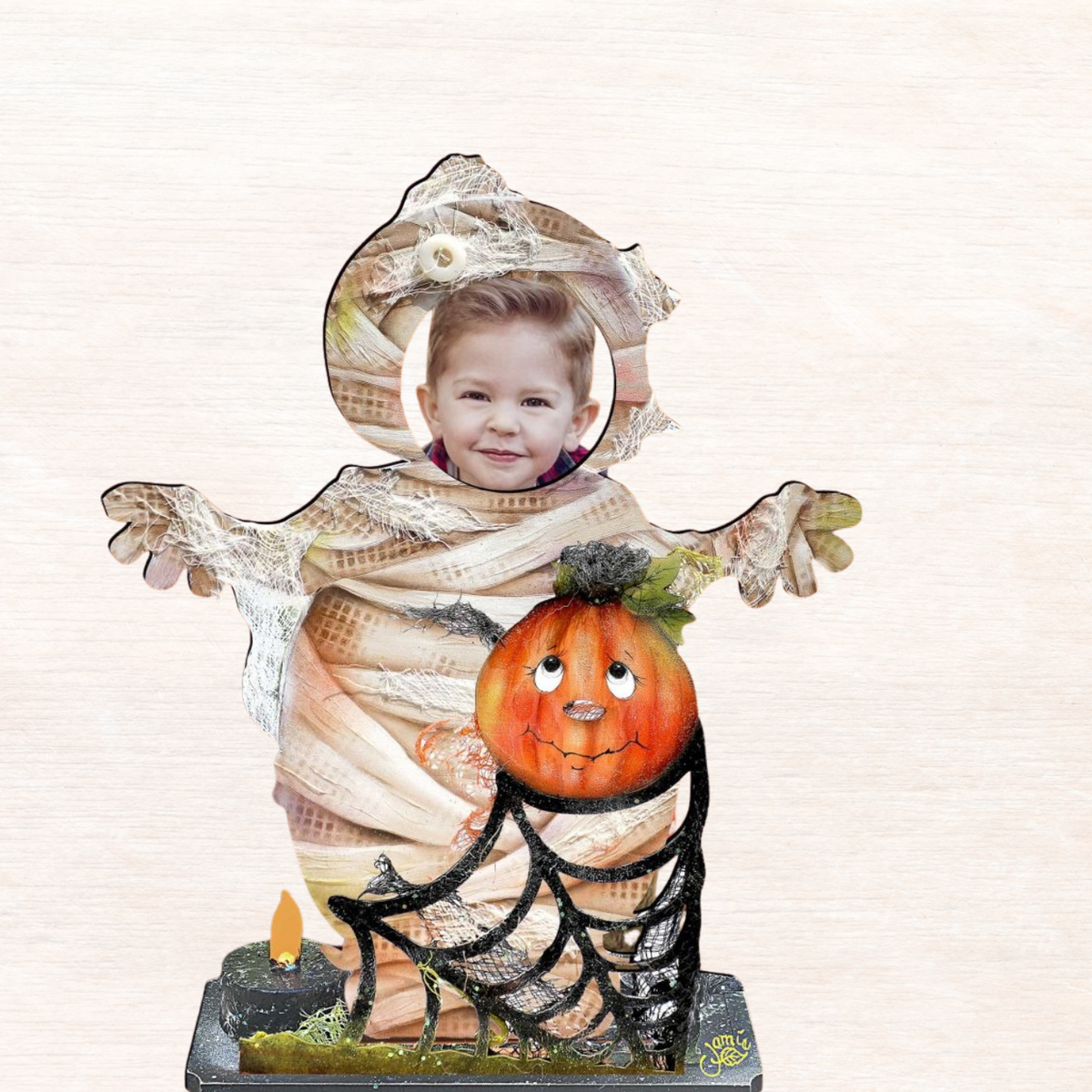 Halloween yard decor figure: child in mummy costume holding jack-o’-lantern on dark base