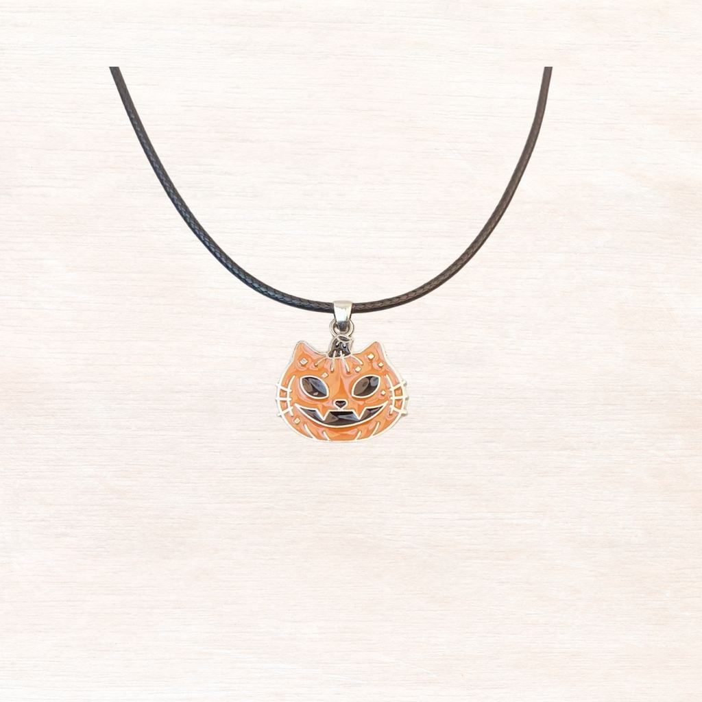 Halloween pumpkin pendant necklace with black cord and orange jack-o'-lantern charm