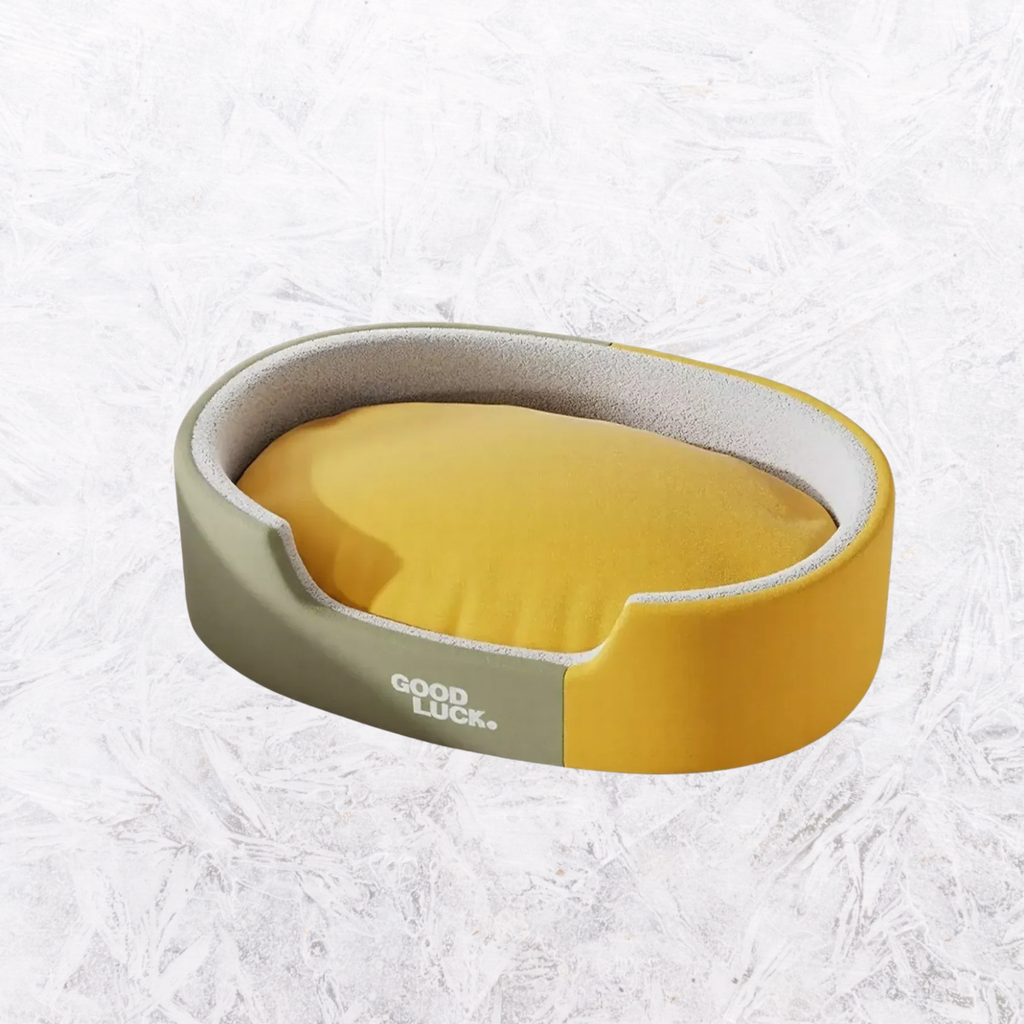 Oval plush pet nest with gray rim and yellow inner cushion, open front