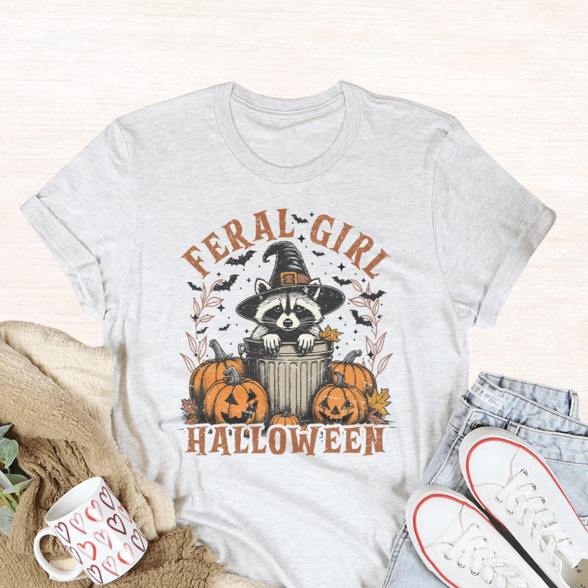 Light gray Halloween graphic tee with raccoon in witch hat and pumpkins