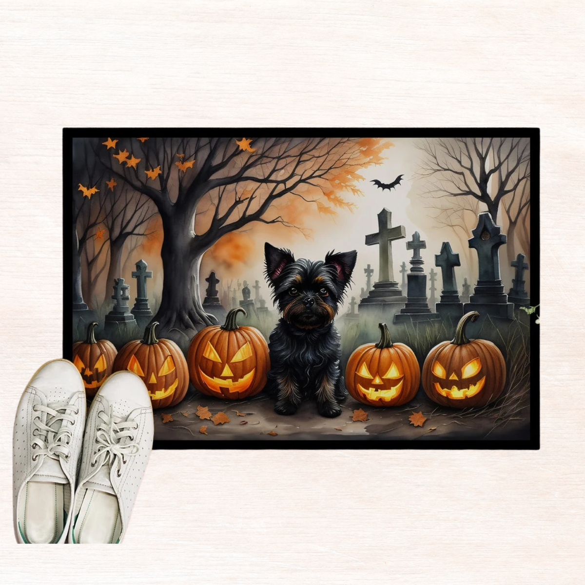 Halloween doormat close-up with Affenpinscher in cemetery beside jack-o'-lanterns