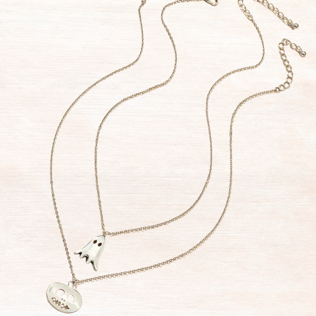 Silver necklace with ghost and pumpkin charms, silver-toned chain and enamel faces.