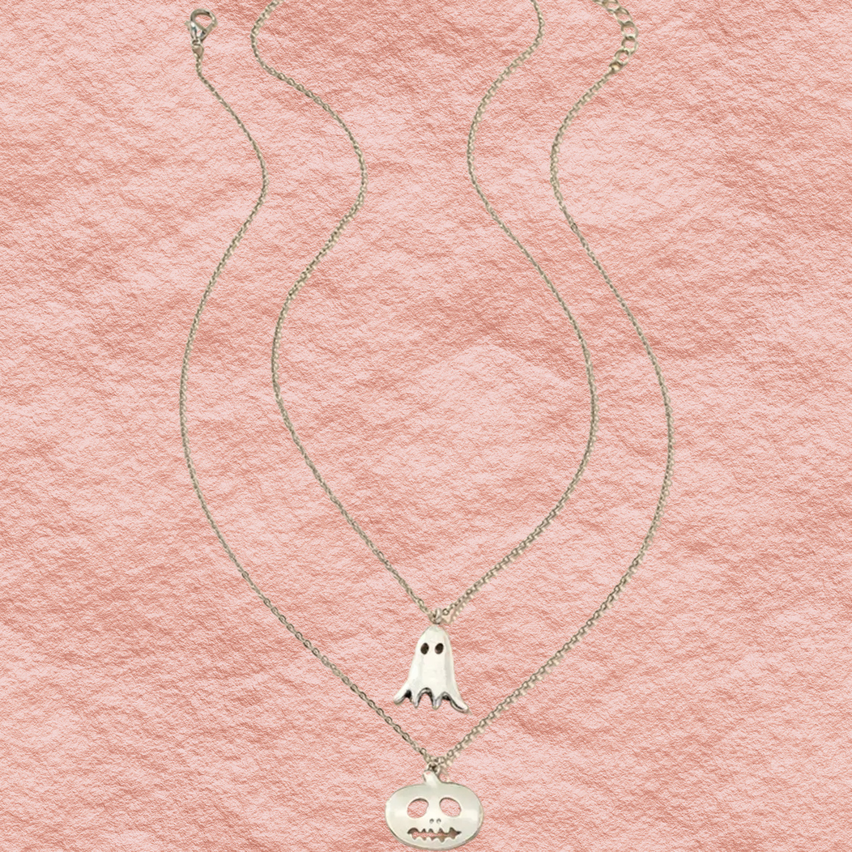 Silver two-strand necklace with ghost charm and round jack-o-lantern charm.