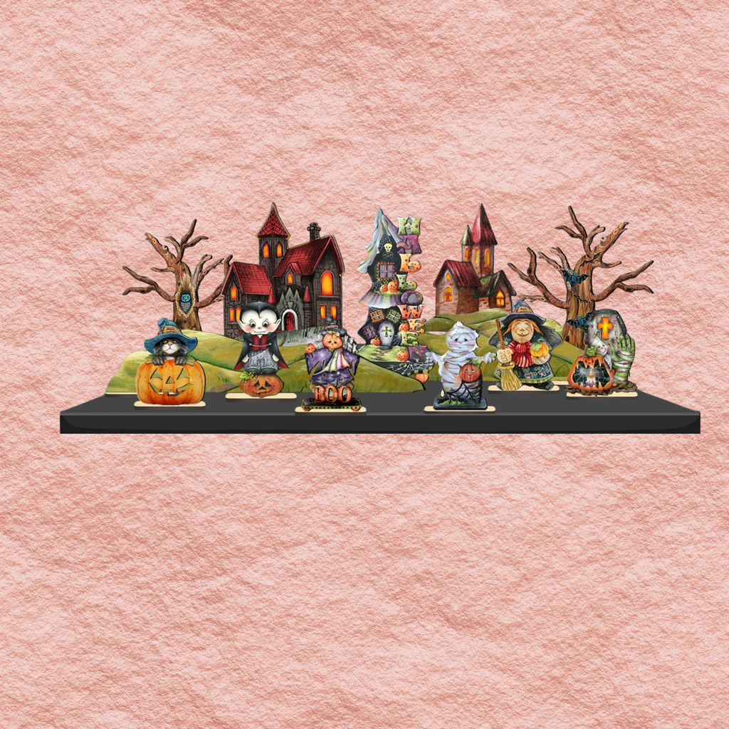 Halloween village figurine set on black base with haunted houses, pumpkins, and characters.