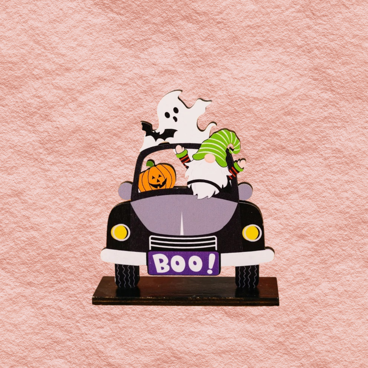 Close-up car-shaped Halloween ornament with ghost, pumpkins, and 'BOO!' front sign