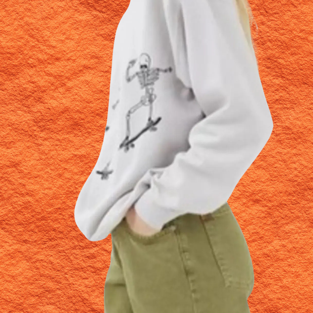 White oversized sweatshirt with black skeleton skateboard graphic on front