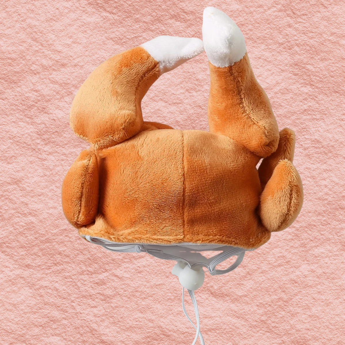 Side view plush orange turkey leg pet headwear with white accents and grey neck strap