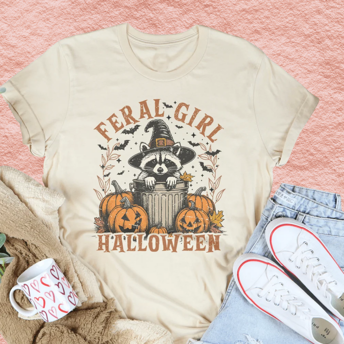 Soft cream Halloween graphic tee with raccoon in witch hat and jack-o’-lantern pumpkins