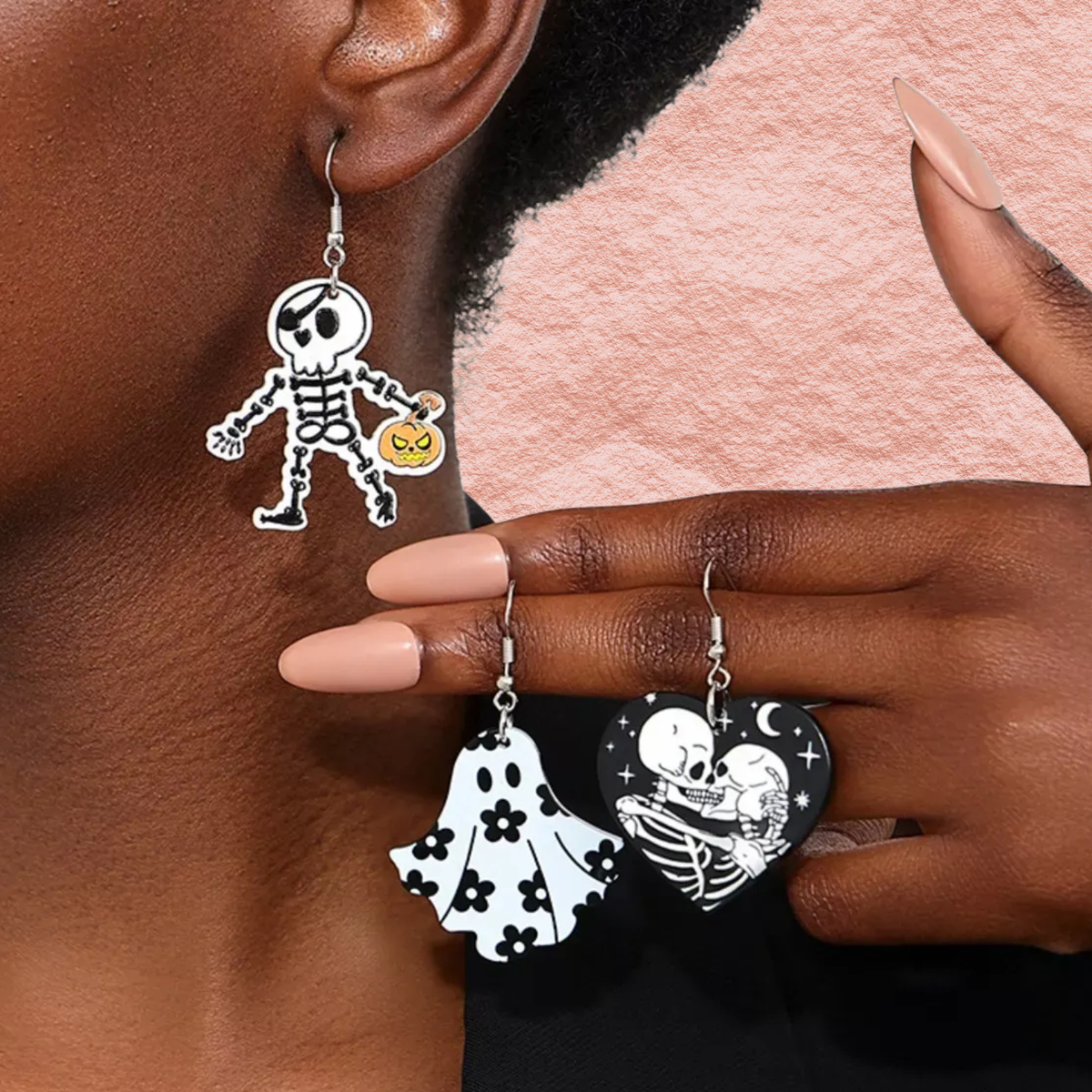 Halloween acrylic dangle earrings on model: skull-heart and skeleton with jack-o'-lantern
