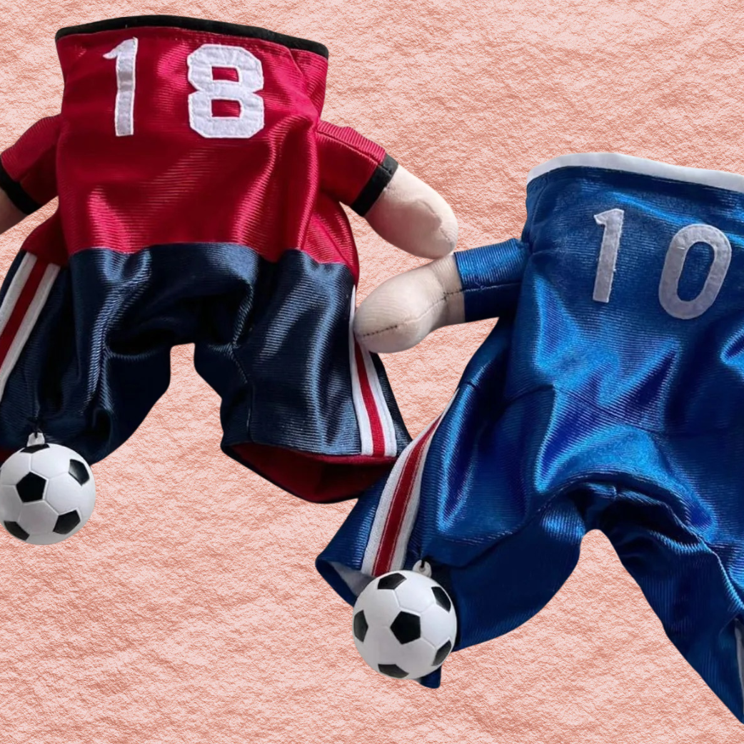Dog jumpsuits side by side: red 18 and blue 10 with striped trim and soccer balls