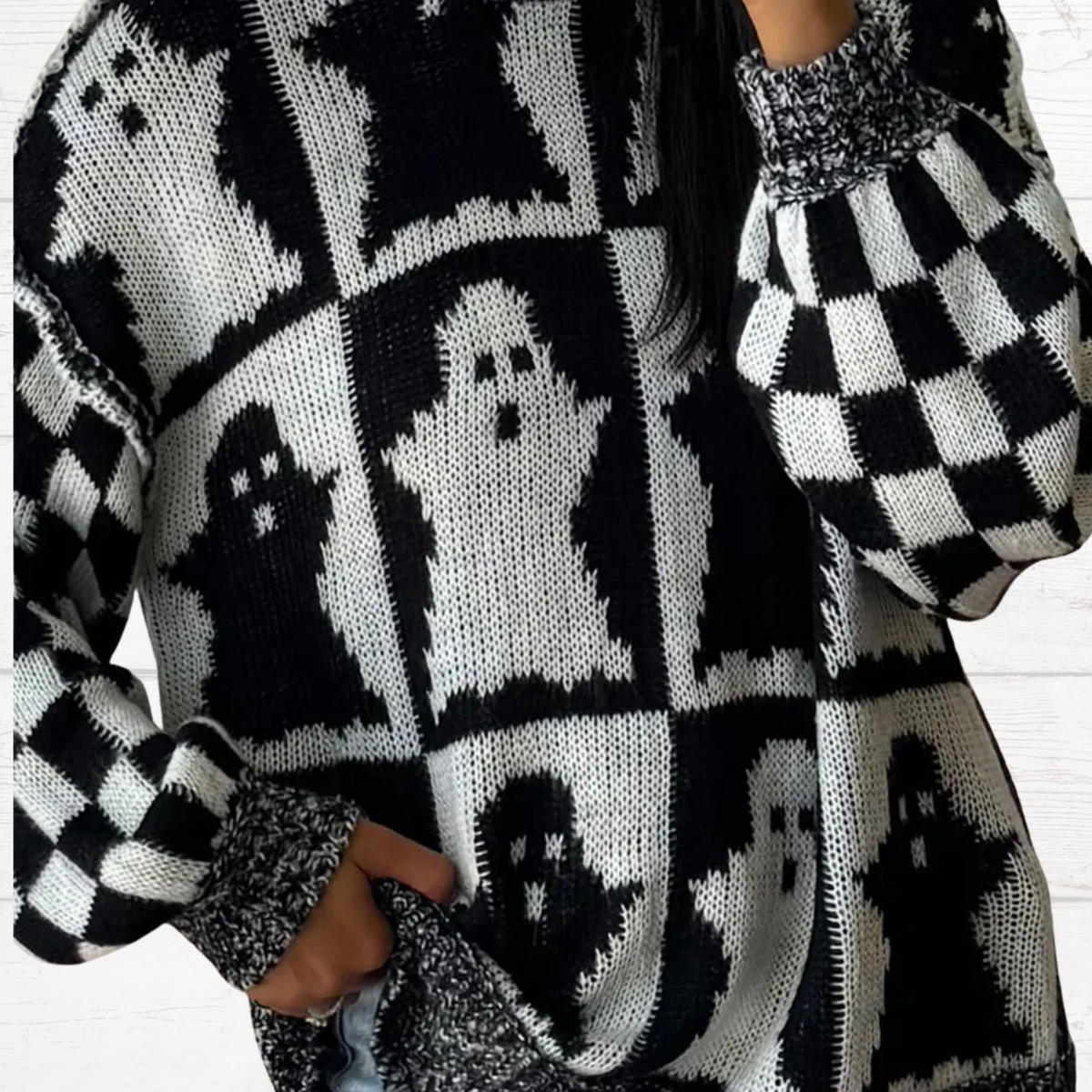 Black and white ghost pattern knit sweater with high neck and checker patch detail