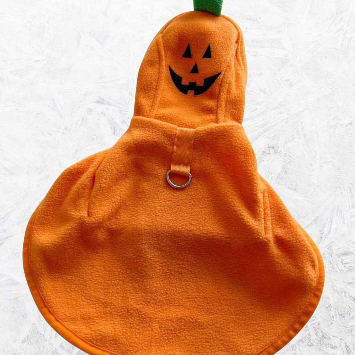 Orange hooded pet costume coat with jack-o’-lantern face on hood and front buckle strap