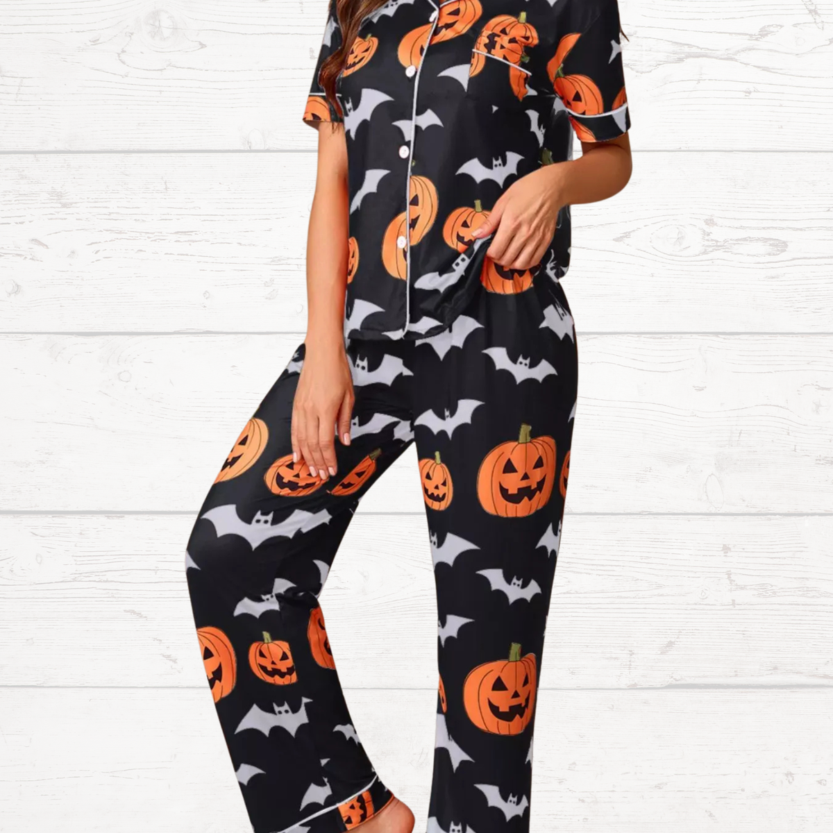 Black Halloween pajama set with short-sleeve button top and lounge pants, pumpkin and bat print
