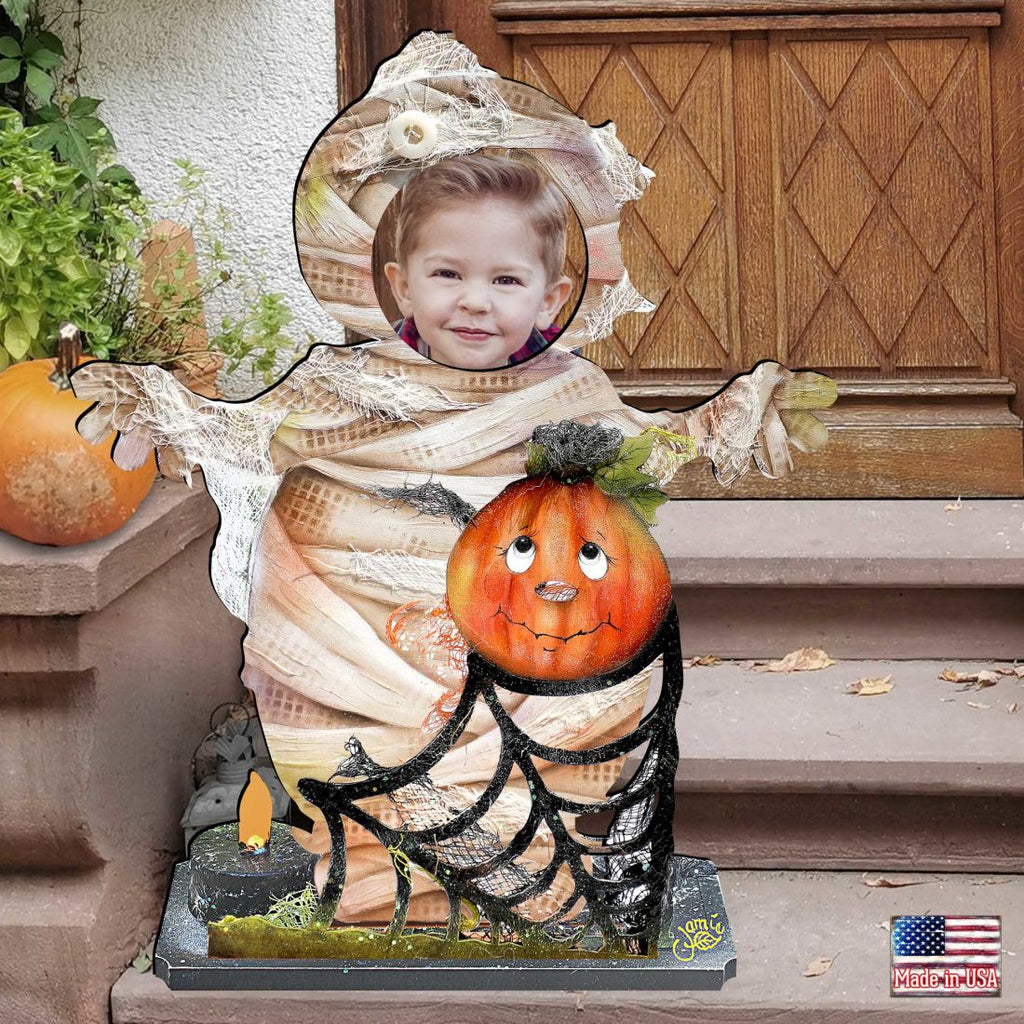 Halloween yard decor figure: child in mummy wrap with jack-o’-lantern and candle base