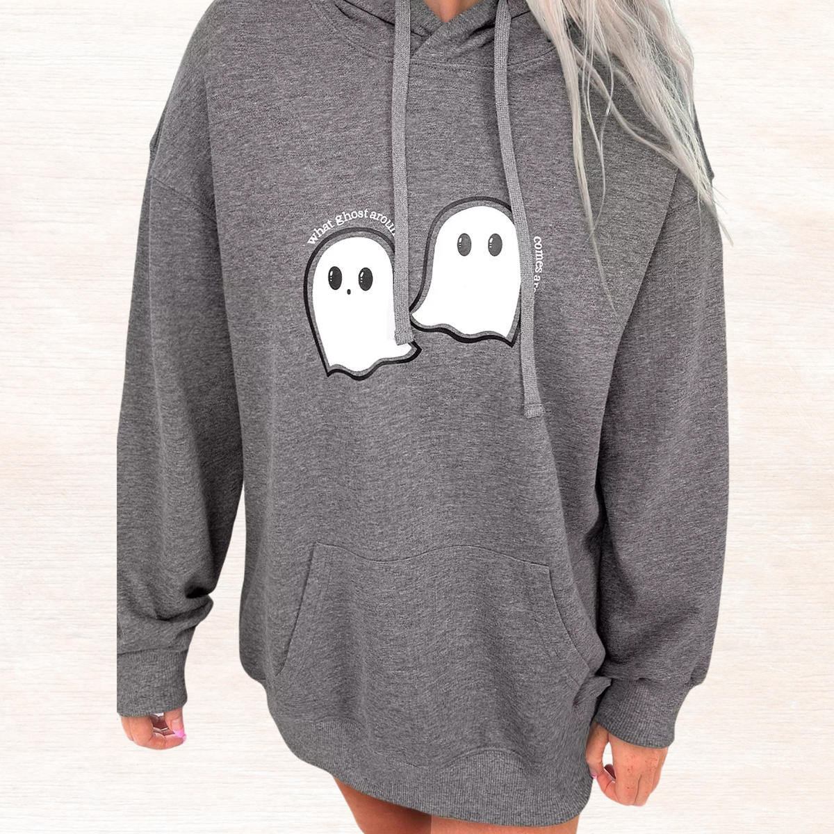 Dark gray oversized hoodie with front ghost print and drawstring hood, side view