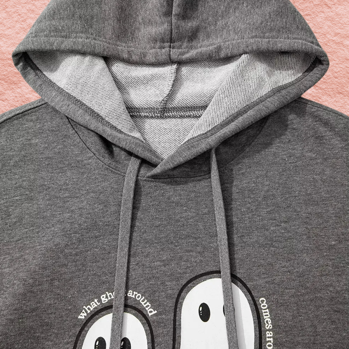 Dark gray oversized hoodie hood close-up with ghost face graphic detail