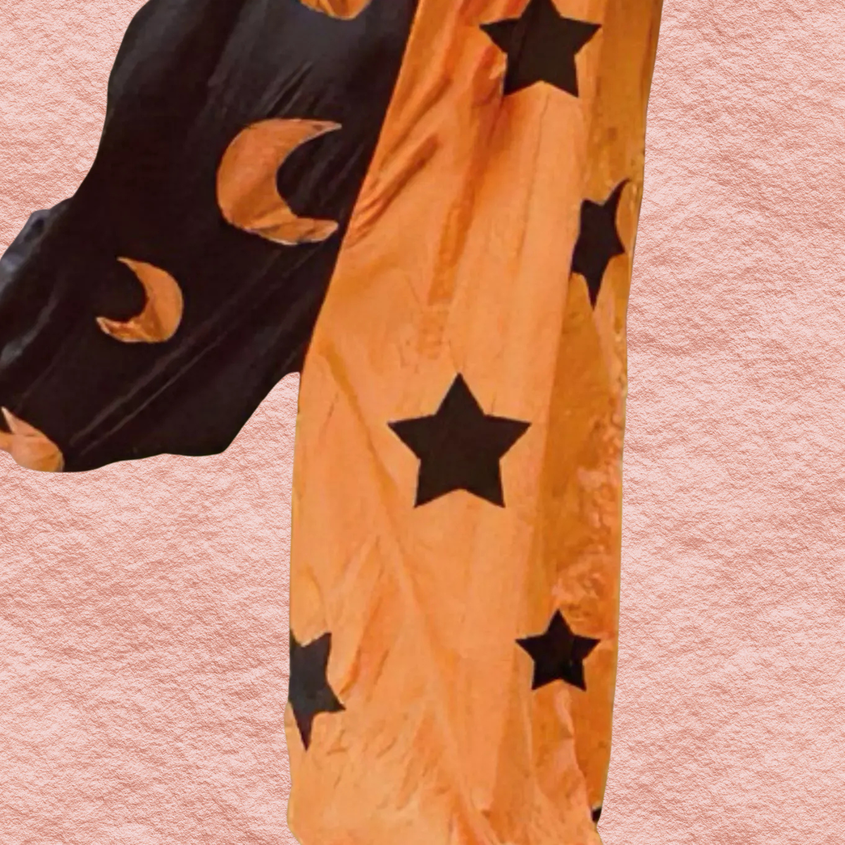 Tangerine and black jumpsuit with large star print and moon accents on long legs