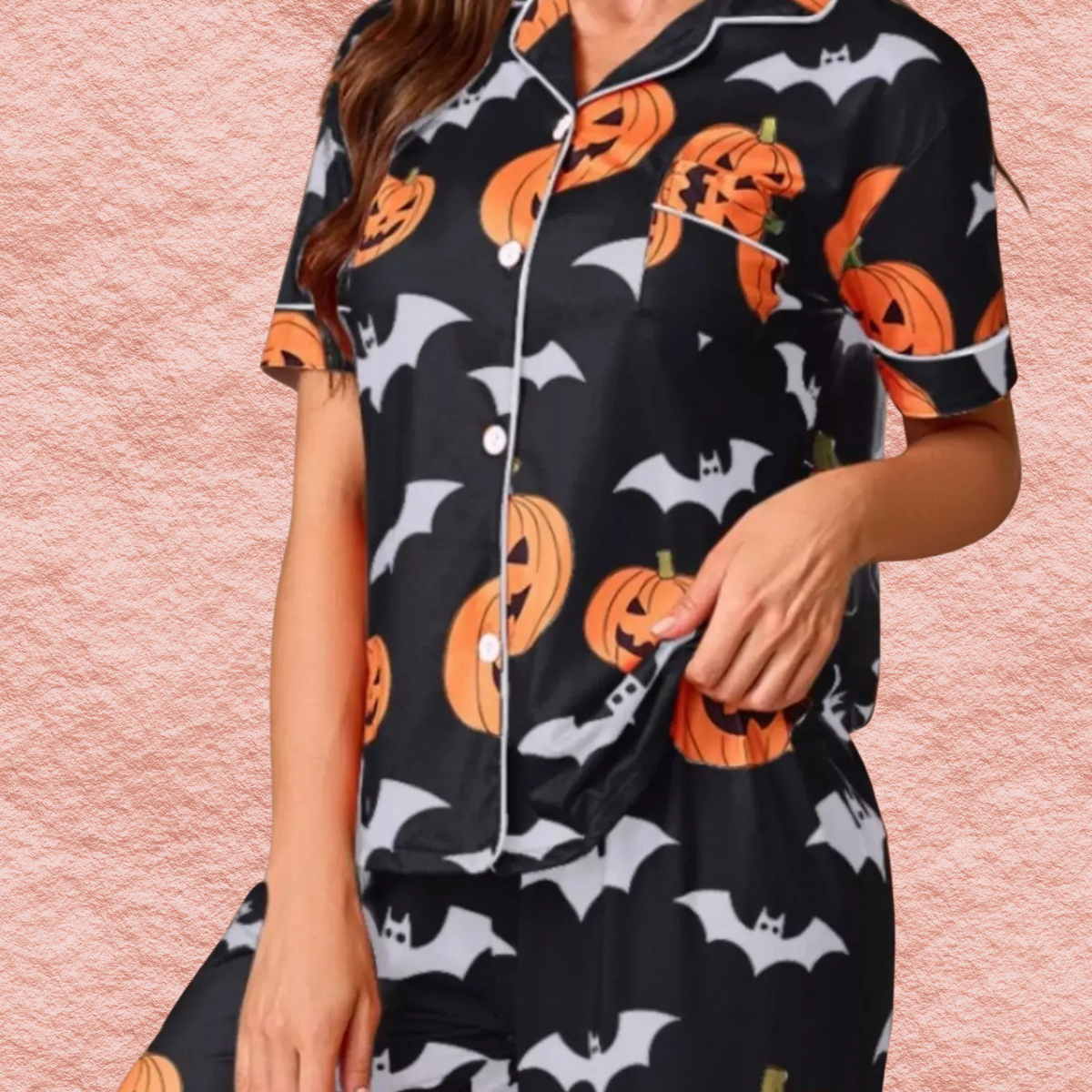 Black Halloween pajama set close-up, short-sleeve button top with pumpkin and bat print