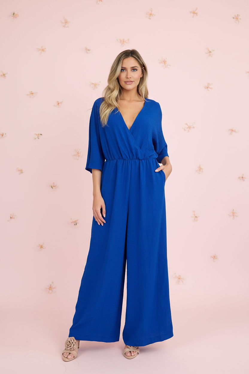 Royal blue surplice V-neck wide-leg jumpsuit with tie waist and pockets