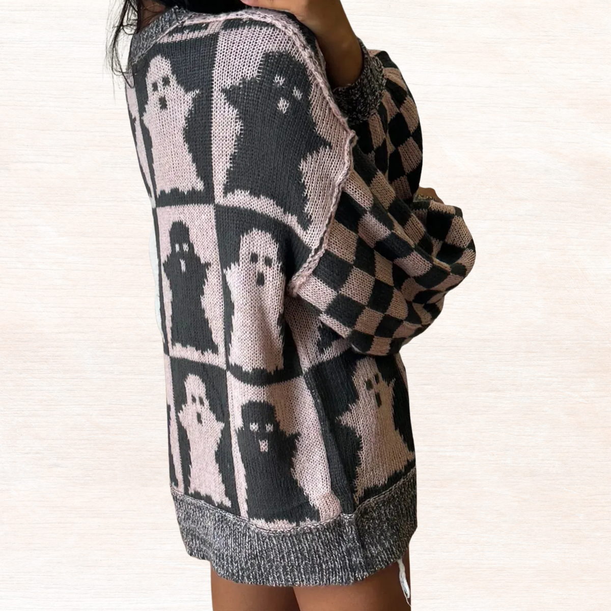 Black and dusty pink ghost knit sweater with checker sleeves and ribbed hem