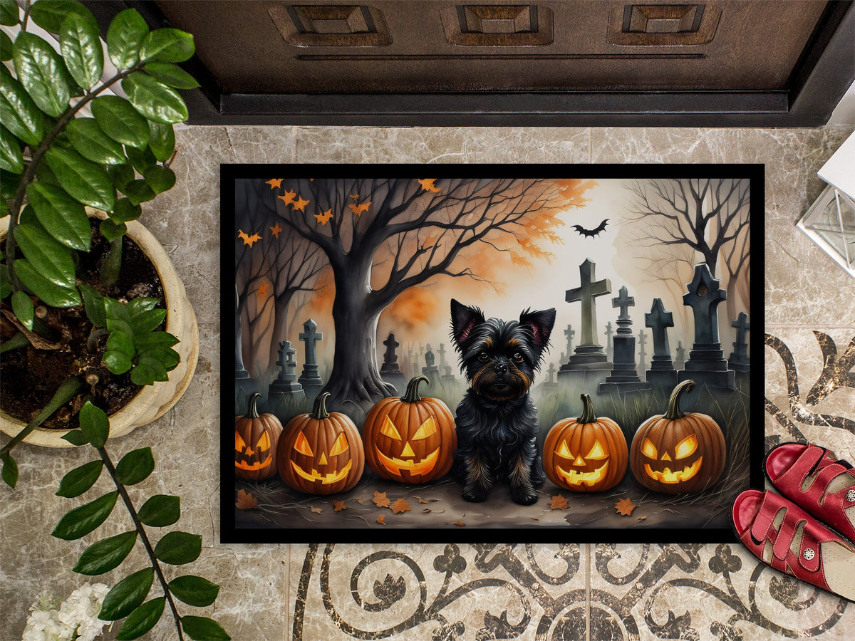Halloween doormat on entryway with Affenpinscher, carved pumpkins, and graveyard silhouettes
