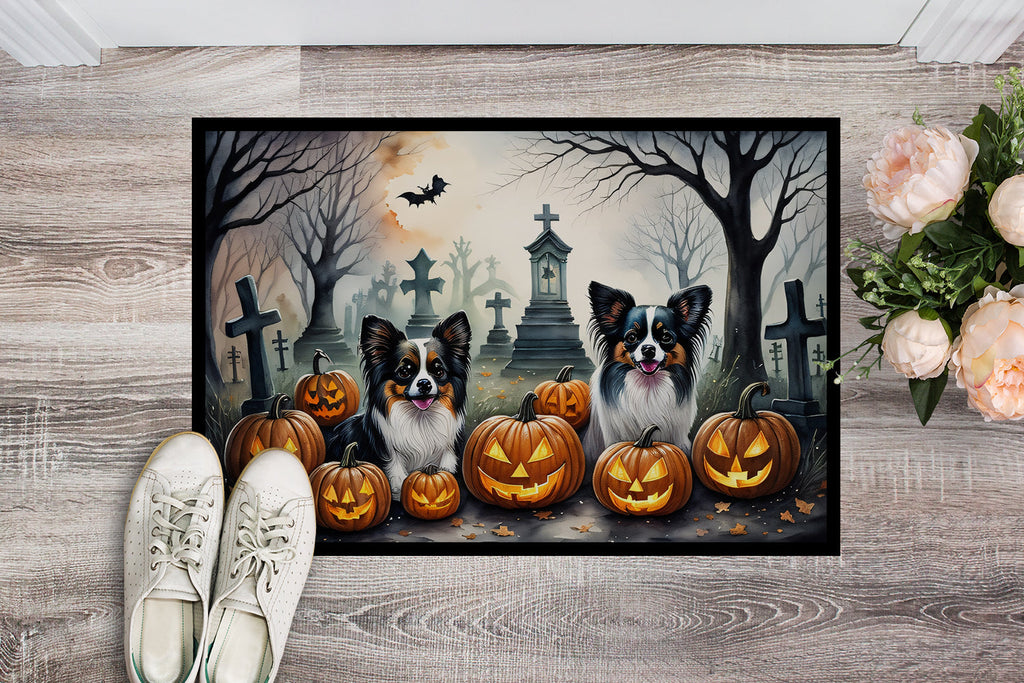 Spooky Halloween doormat featuring two dogs among jack-o'-lanterns and tombstones