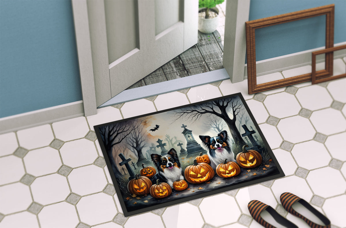 Spooky Halloween doormat with two dogs, jack-o'-lanterns, and graveyard crosses