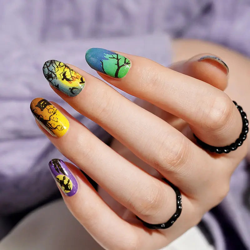 Halloween patterned press-on nails with black, yellow, blue, and purple designs