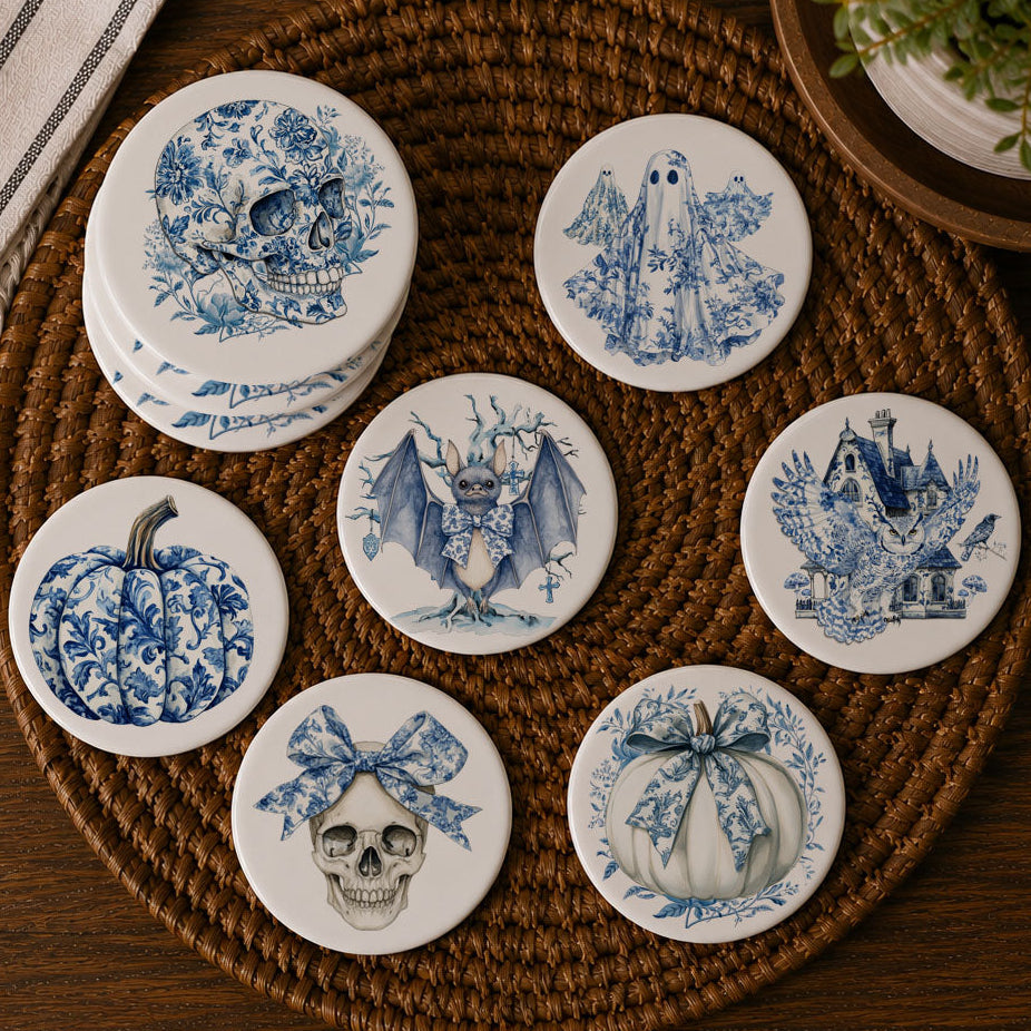 Assorted blue-and-white Halloween coaster designs on a round woven tray