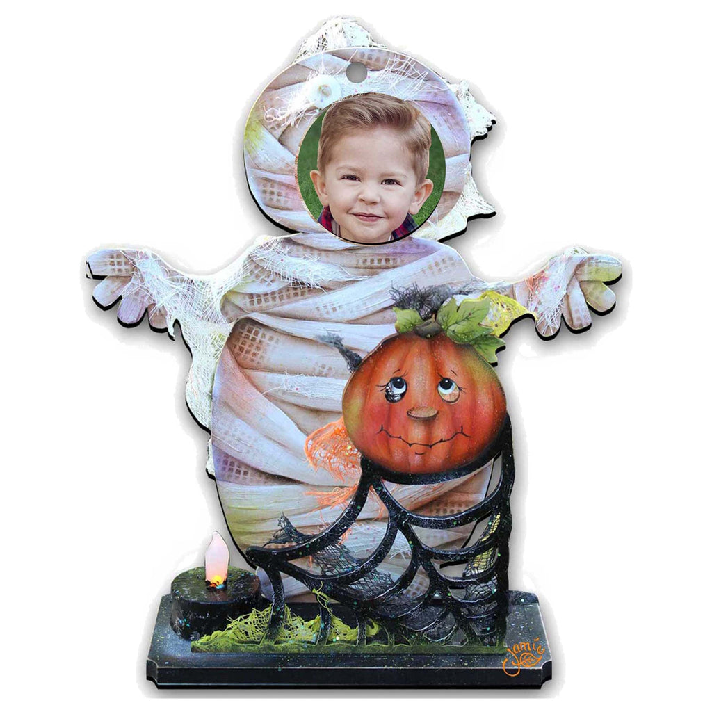 Halloween yard decor figure: child in mummy costume holding a jack-o’-lantern