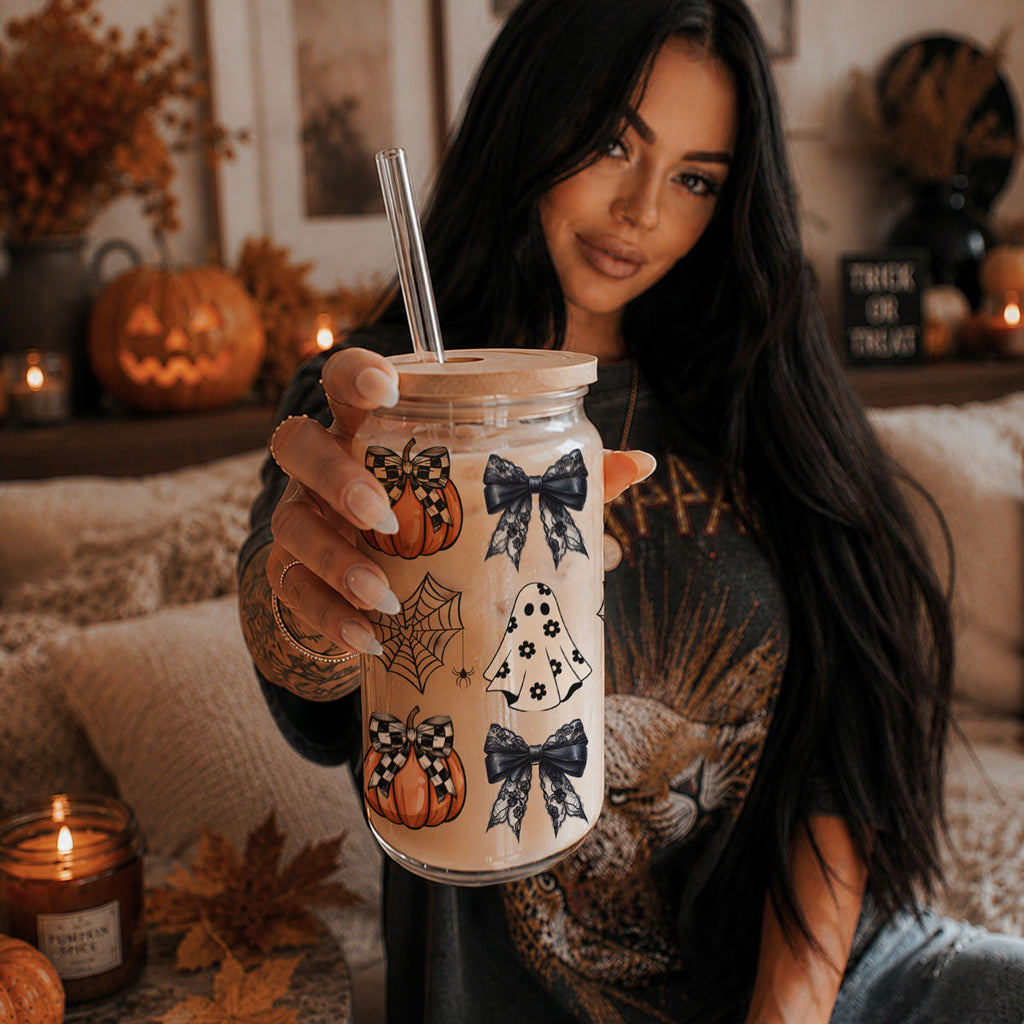 Woman holding a 20oz Halloween drink jar with straw, wooden lid, pumpkins and bats print